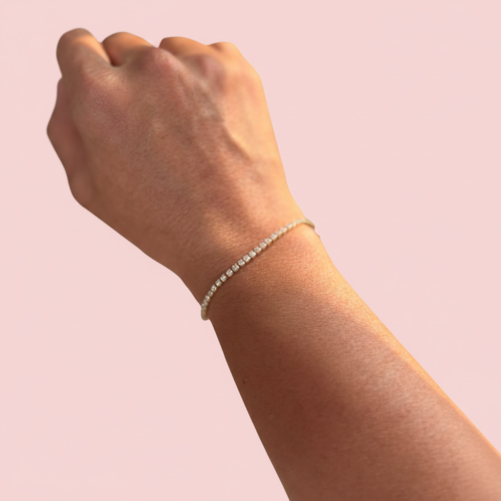 Hand wearing a bracelet with a blurred natural background