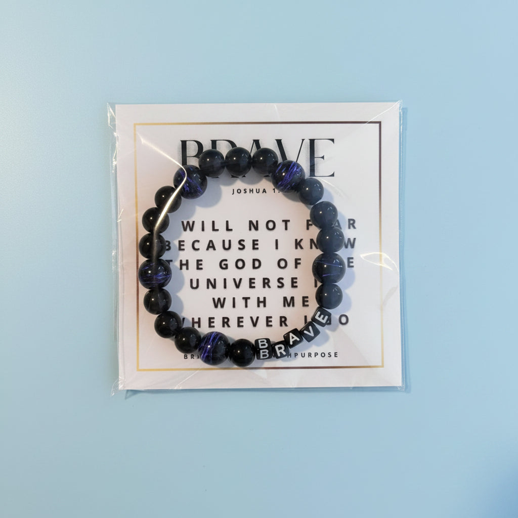A packaged Brave Kids bracelet with black and purple beads, displayed in front of a white background with the brand name 'Brave' written on it.