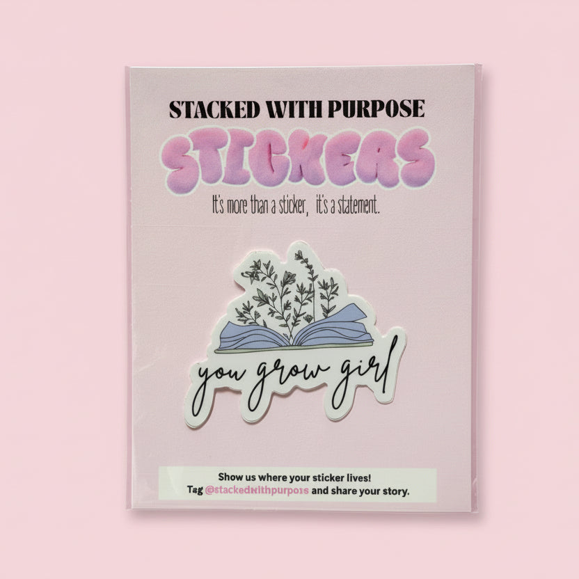 Pink stickerbook with stickers and a hand holding it