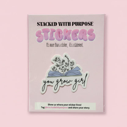 Pink stickerbook with stickers and a hand holding it